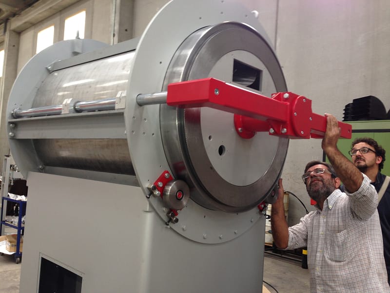 Innoenvas staff members inspecting the quality of a coffee roaster part
