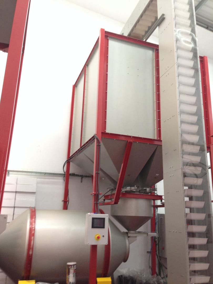 Bucket elevator for transporting coffee in a coffee production plant